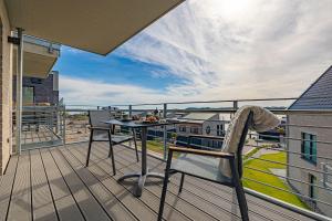 a balcony with a table and chairs on a roof at Ferienwohnung Wiking-Koje 7 Schleswig in Schleswig +26 photos