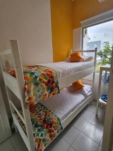 a room with two bunk beds and a window at VILLA SANTORO Casa playa de Castelnuovo-Atacames in Atacames +26 photos