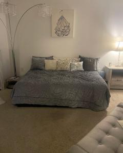 a bedroom with a large bed with pillows at Tucked in Little Tokyo in Los Angeles