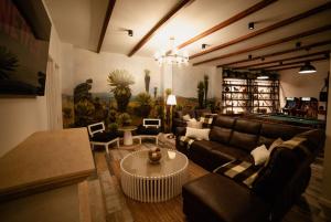 a living room with a couch and a table at Hotel San Luis Mongui in Monguí