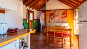 a kitchen and dining room with a table and chairs at Casa al Río in El Chalten +12 photos