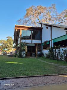 a building with a grassy yard in front of it at Pousada Real Cipo in Serra do Cipo
