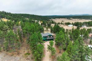 an aerial view of a house in the middle of a forest at Crystal Retreat Cabin - Hot Tub BBQ Eco Escape in Florissant