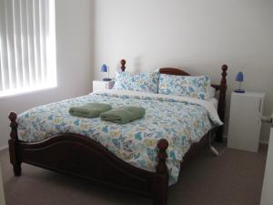 a bedroom with a bed with two pillows on it at Hayden House in Delegate