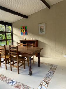 a dining room with a wooden table and chairs at Pousada DAldeia in São Sebastião