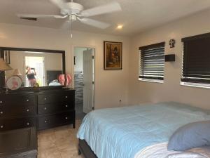 a bedroom with a bed and a dresser and a mirror at My Garden in Miami Florida in Palmetto Bay