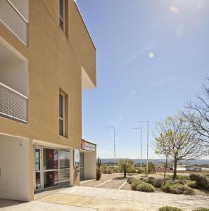 a large building with a view of the ocean at Séjours & Affaires Manosque Le Moulin Neuf in Manosque