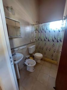 a bathroom with a toilet and a sink at Lo de nina in Miramar