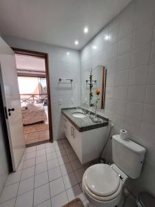 a white bathroom with a toilet and a sink at Costa Oeste Itaparica in Itaparica Town +18 photos