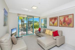 a living room with a couch and a table at Argyle on the Park in Maroochydore