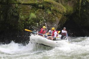 a group of people in a raft on a river at Private Costa Rica Mountain House Pool & Stunning Views in Turrialba