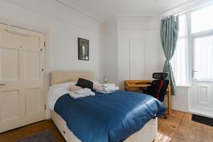 a bedroom with a bed with towels on it at Hullidays University 2 Bed Ground Floor Apartment in Hull