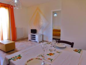 a dining room with a table with wine glasses on it at Residence Stella Del Gran Sasso in Colledara