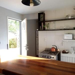 a kitchen with a stove and a stove top oven at Las Grullas in Mar de Cobo +9 photos