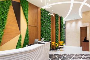 an office lobby with a green wall at Hotel YX Lai Chi Kok in Hong Kong