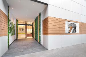 a hallway with a hotel sign on a wall at Hotel YX Lai Chi Kok in Hong Kong