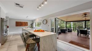 a kitchen and living room with a table and chairs at Mount Gibraltar Retreat in Mittagong +16 photos