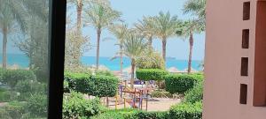 a view of a resort with palm trees and a playground at Palmera El Sokhna Chalets Families Only in Ain Sokhna