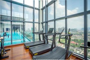 a gym with a swimming pool in a building at Novo Kuala Lumpur by Cobnb, Jalan Ampang in Kuala Lumpur +260 photos