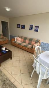 a living room with a couch and a table at Casa do Jardim in Curitiba
