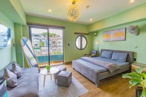 a bedroom with a bed and a couch at Green House - Căn hộ có bếp riêng in Da Lat