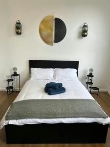 a bedroom with a bed with a blue towel on it at City-Centre Studio · Self-Contained · Sleeps 3 in Nottingham