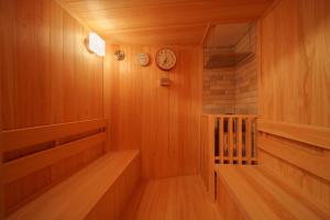 a sauna with clocks on the wall and wooden floors at 【Newly Opened】Yufuin Geihinkan Kura in Yufuin