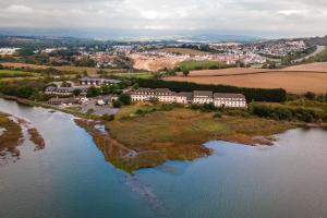 an aerial view of a house on an island in the water at Passage House Hotel in Newton Abbot