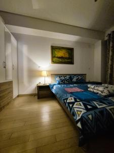 Un dormitorio con una cama y una lámpara. en Flatiron Royal Apartment, en Skopje 6 fotos más
