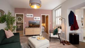 a living room with a couch and a tv at Easy Reach in Ambleside
