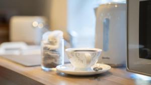 a cup of coffee sitting on a counter top at Easy Reach in Ambleside