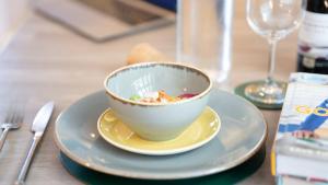 a bowl of food on a plate on a table at Easy Reach in Ambleside