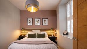 a bedroom with a large bed with two pillows at Easy Reach in Ambleside