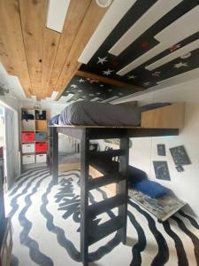 a bunk bed in a room with a zebra patterned floor at Electric Waihi Beach House - family & dog friendly, close to beach, pool table, outdoor fire room, skate ramp in Bowentown