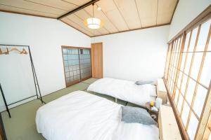 Postel nebo postele na pokoji v ubytování Fujiクロスゲートハウス 離 -HANARE-
