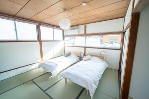 Postel nebo postele na pokoji v ubytování Fujiクロスゲートハウス 離 -HANARE-
