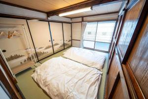Postel nebo postele na pokoji v ubytování Fujiクロスゲートハウス 離 -HANARE-