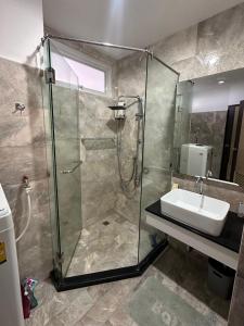 a bathroom with a shower and a sink at Nai Harn Beach Condo (C2) in Rawai Beach