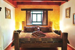 a bedroom with a bed in a room with a window at Odem Habar in Odem