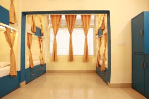 una camera con porte blu e una finestra di Shiv Shakti Hostel a Rishikesh Altre 27 foto