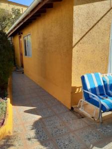 a blue chair sitting on a patio next to a building at Casa Jardín del Mar- Reñaca Beach-Frente a Unimarc in Viña del Mar