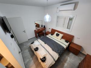 a bedroom with a large bed and a television at Short term Stay in Rehovot Central location near Nes Ziona Rishon Lezion Jerusalem and Tel Aviv in Rechovot
