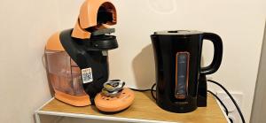 a coffee maker and a blender on a shelf at Studio Excellence Tulle in Tulle
