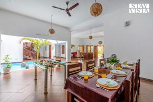 a dining room with a table with plates of food at StayVista at Wellbeing Villa in Wayanad +28 photos