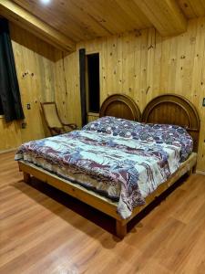 a bedroom with a bed in a wooden room at Casa del árbol in Pachuca de Soto +33 photos