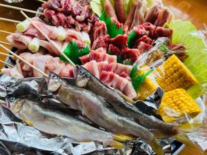 a plate of food with fish and other meats at ラフォーレハウス in Hitoyoshi