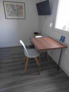 a wooden table with a chair and a desk at Studio 76 - Balcon, proche Bâle in Saint-Louis