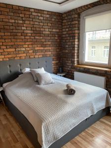 Posteľ alebo postele v izbe v ubytovaní Apartament Pogodny