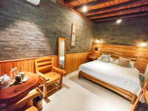 a bedroom with a bed and a table and a desk at Governor's Mansion in Yangshuo