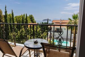 a balcony with a table and chairs and a view at Blue Bay Hotel in Iraklitsa